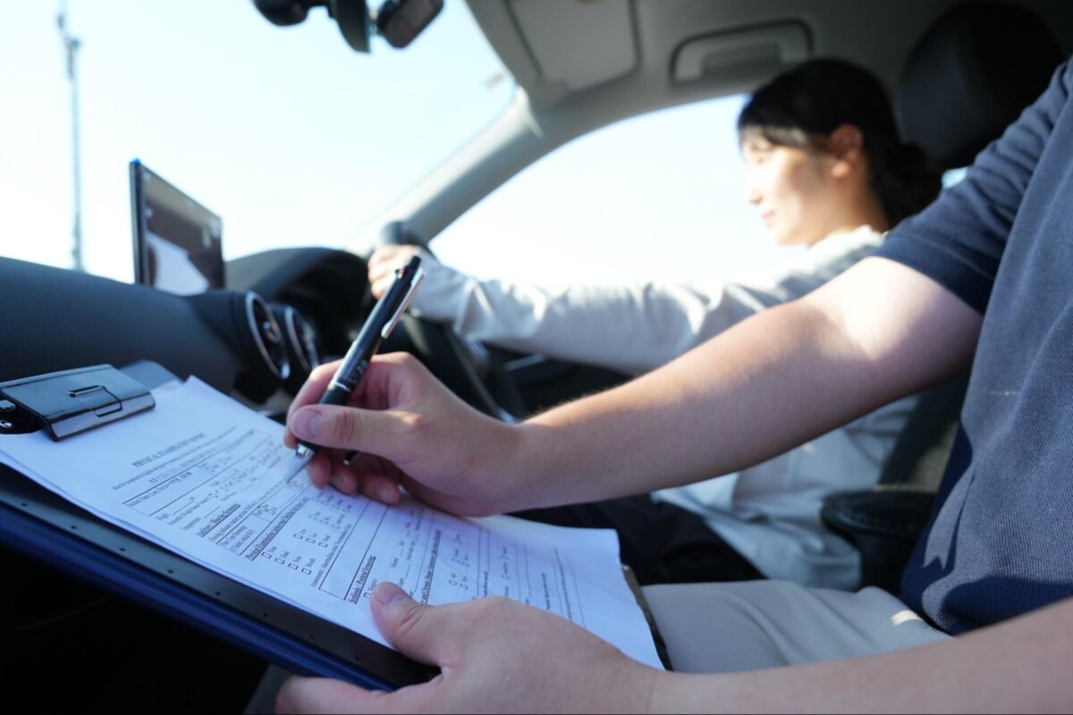 Driving Instructor evaluating a woman studying for US driver's license conversion in Japan